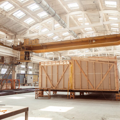 House under construction with prefabricated containers and ladders
